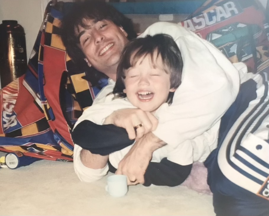 Brandon laughing in a warm embrace during a family moment